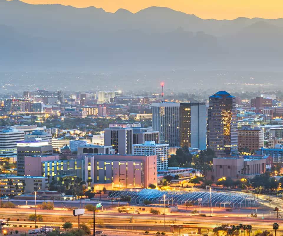 Downtown Tucson at dusk, with the mountains beyond it