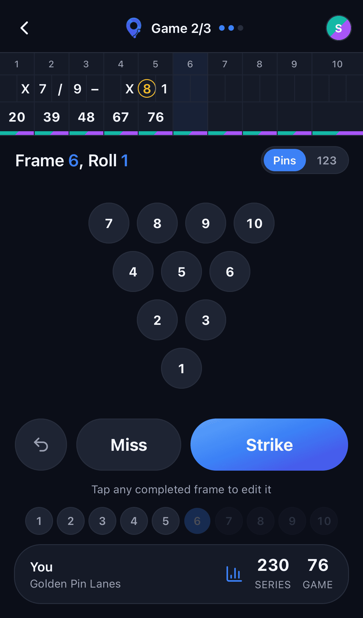The pin deck mid-game, tapping the pins left standing after a ball